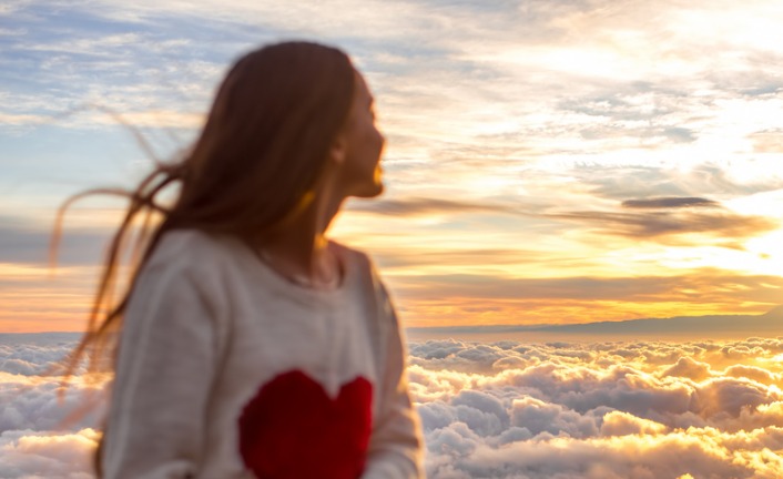 woman-enjoying-beautiful-cloudscape-picture-id513108430